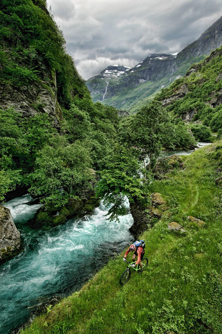 MOUNTAIN BIKER AND GLACIER RIVER