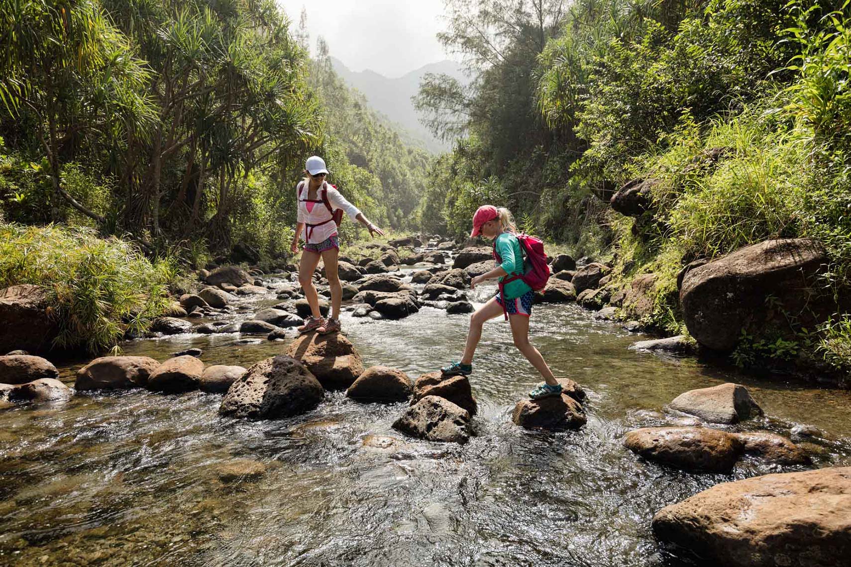 mother-and-daughter-crossing-a-creek_Na-Pali-Coast_Kauai_Hawaii